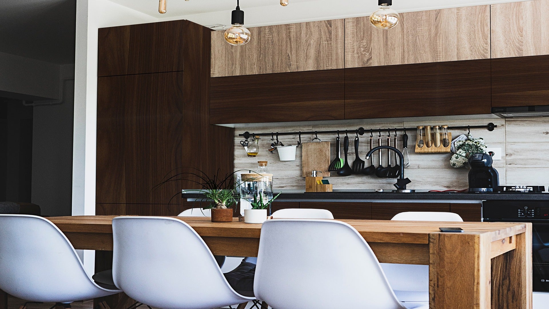 Wood laminate kitchen cabinets and backsplash with wood grain texture and matte finish in dark and light tones.