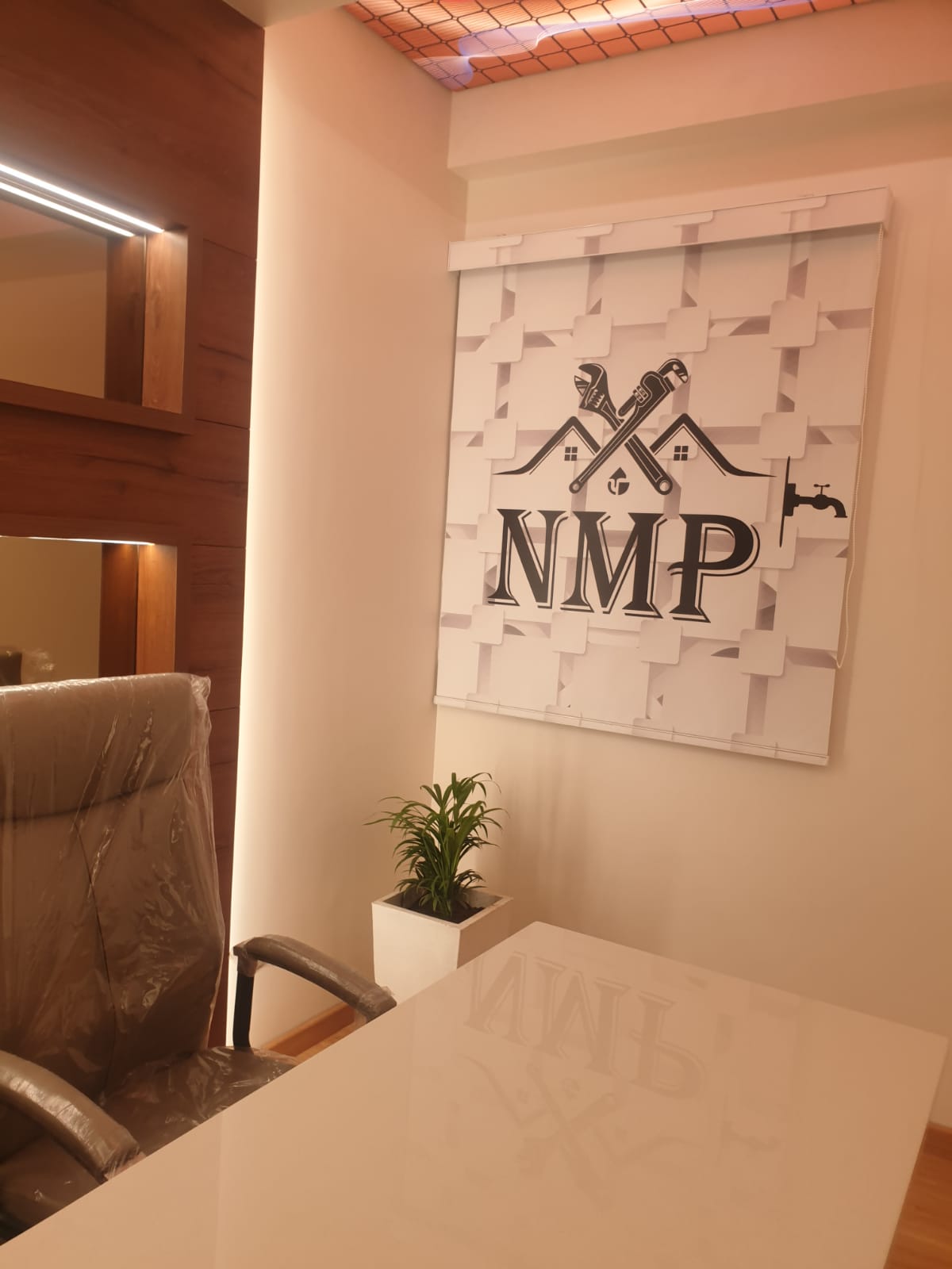 Wood laminate interior with matte finish, visible wood grain texture, used on wall and ceiling in modern office setting