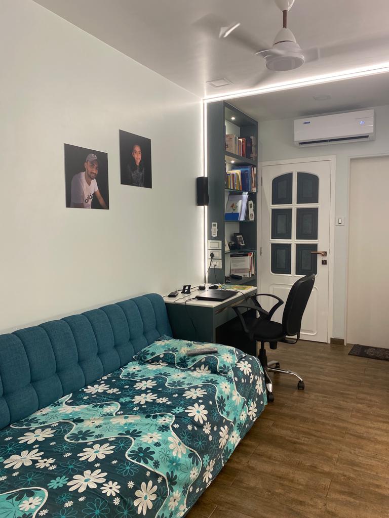 High gloss solid colour laminate in a modern room with white walls and dark wood flooring, showing reflective surface.