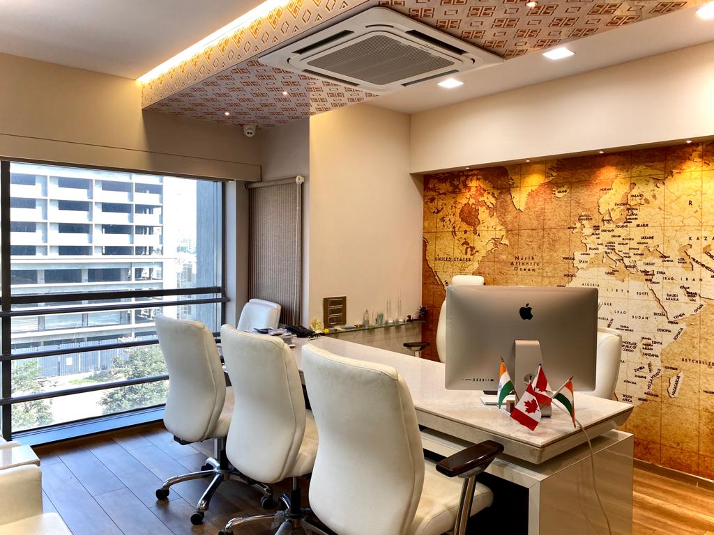 High gloss decorative laminate used on office ceiling with geometric pattern and map wall background in modern workspace