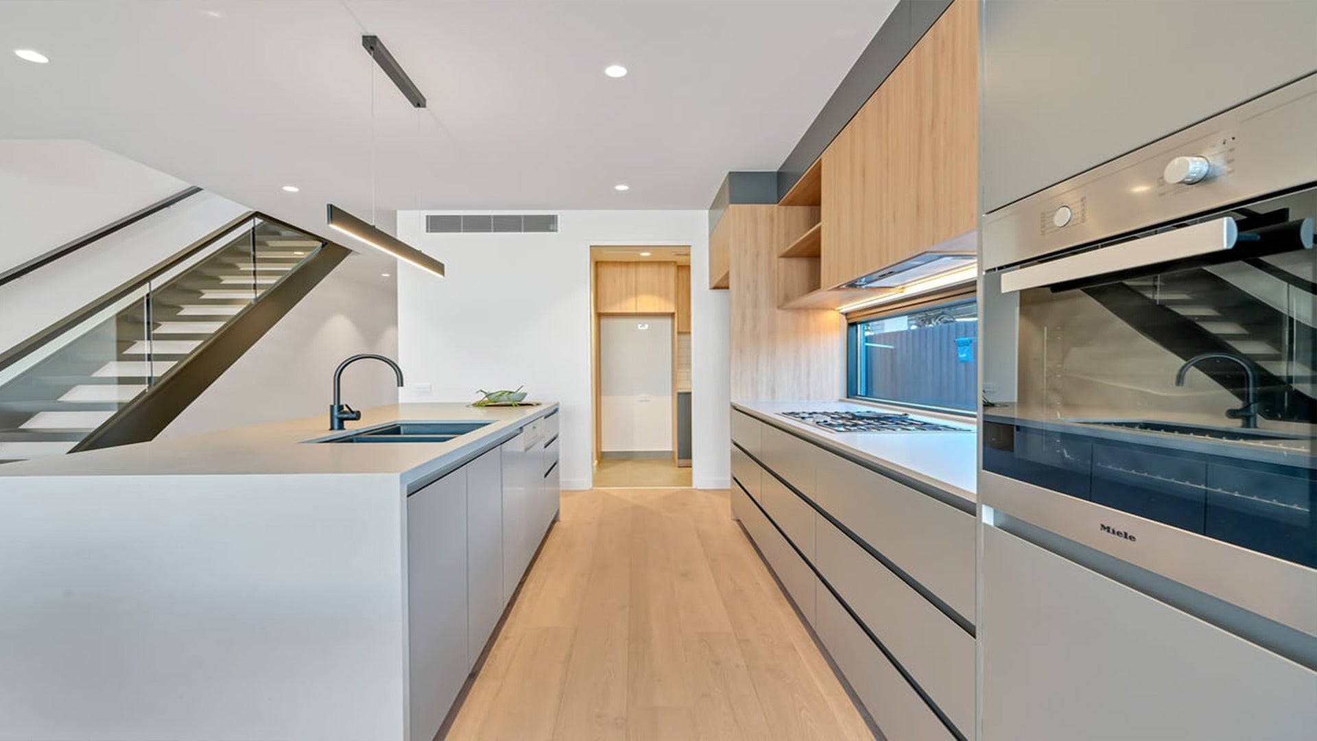 Multicoloured patterned laminate with high gloss finish and abstract design, used in modern kitchen cabinets and countertops.