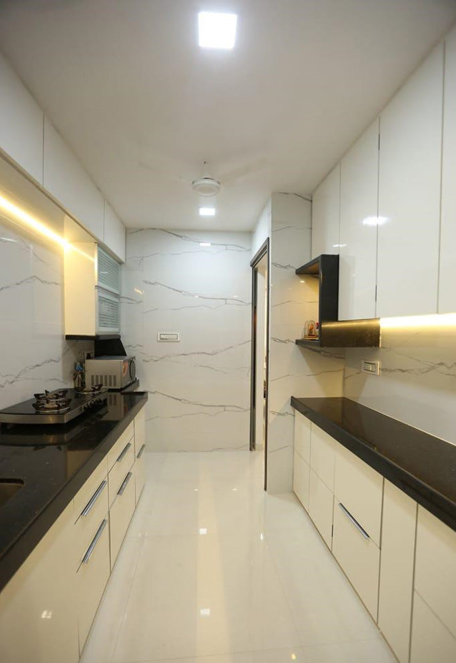 High gloss green laminate in a modern kitchen with sleek white cabinets and black countertops, showing reflective surface.