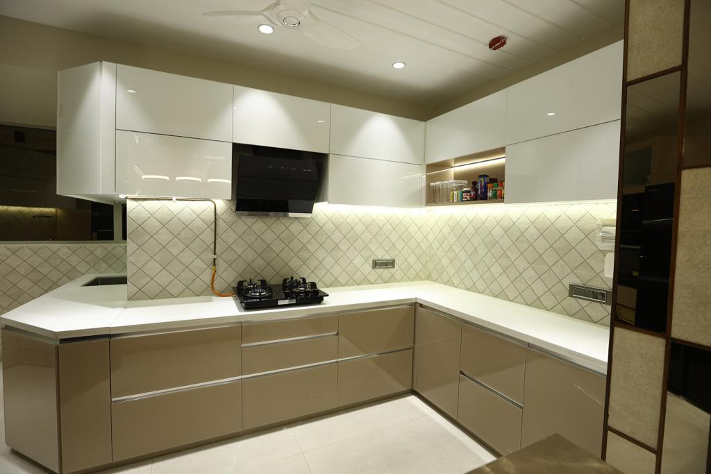 Brown high gloss laminate kitchen cabinets and white countertop with diamond patterned backsplash in modern kitchen interior