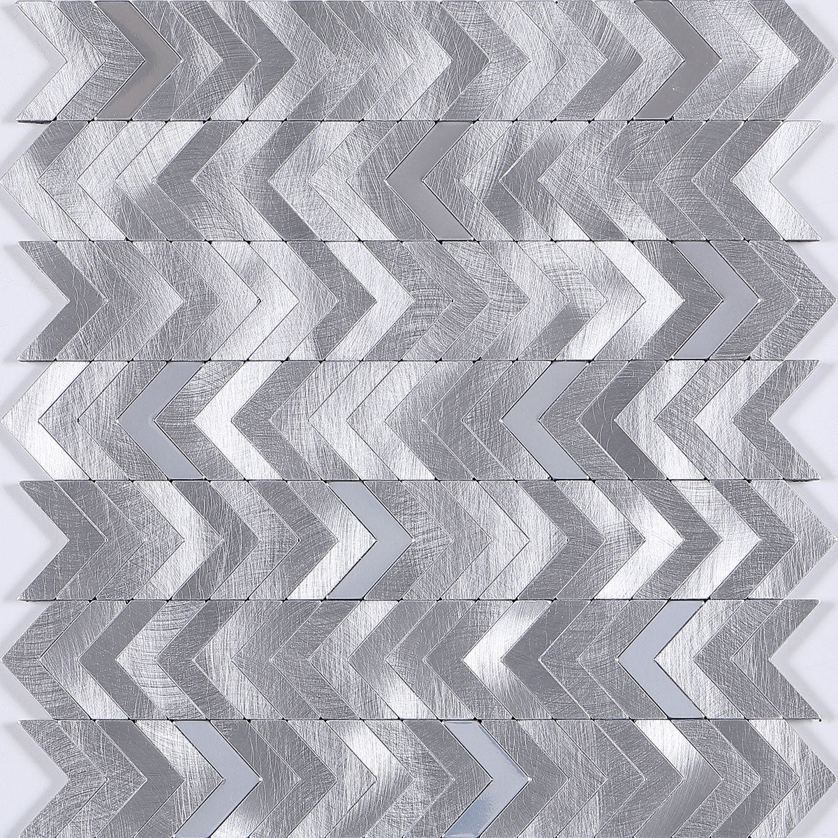 Silver metallic louver with textured chevron pattern and brushed finish, arranged in a zigzag design on a wall panel.