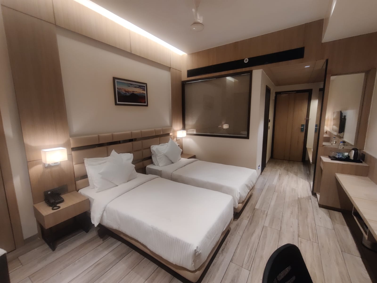 Wood laminate used in hotel room with light wood grain finish on walls and floor creating a modern ambiance.