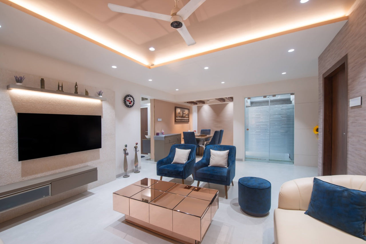 Wood laminate wall in modern living room with blue chairs and cream sofa, showing matte finish and wood grain texture