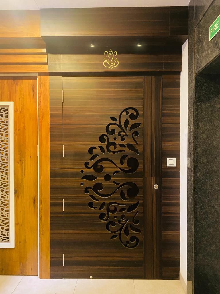 Dark wood laminate cabinet with floral cutout design and matte finish in a modern interior setting