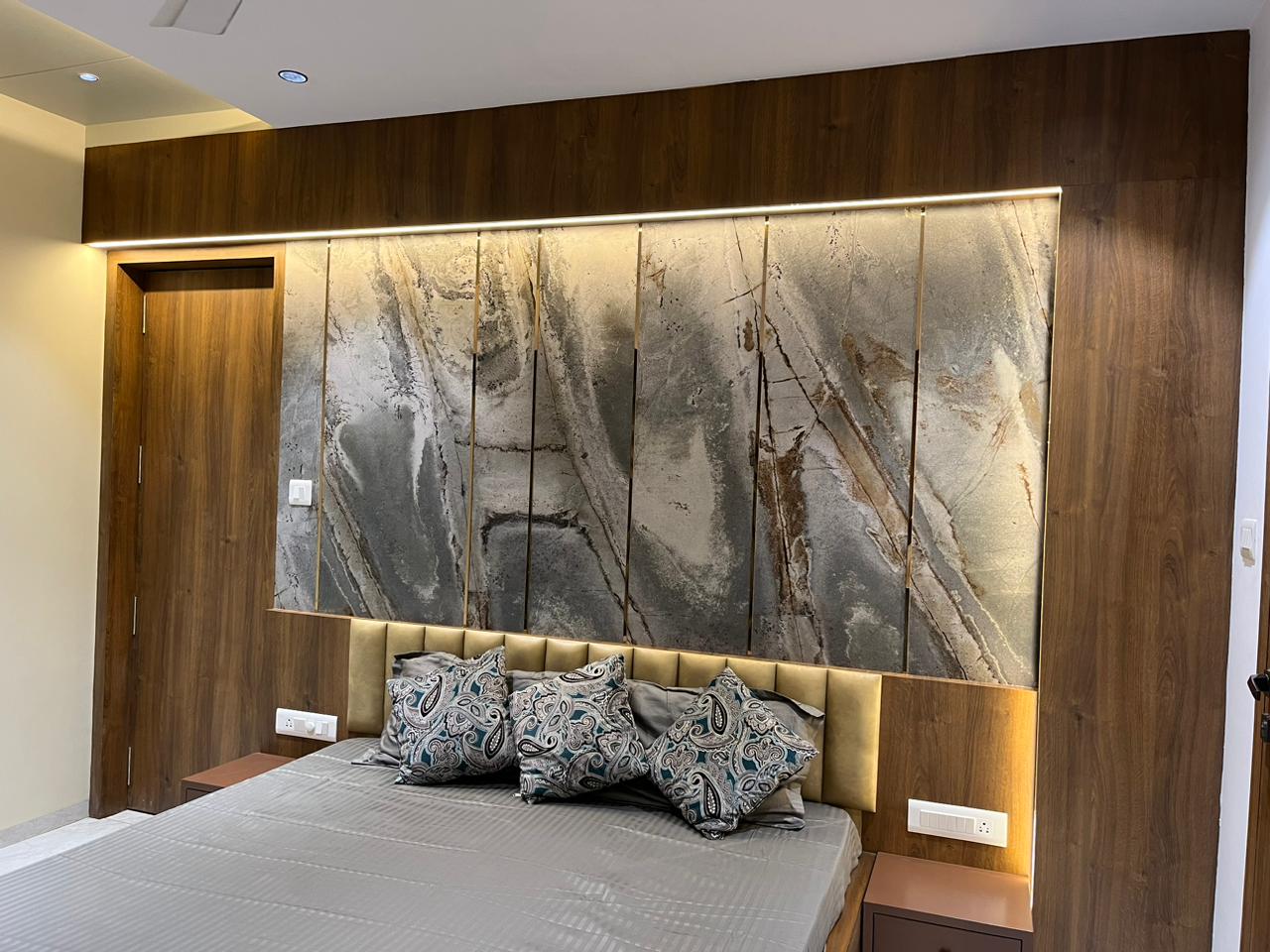 Multi-coloured marble patterned laminate wall panel with matte finish in modern bedroom interior design setting with wooden