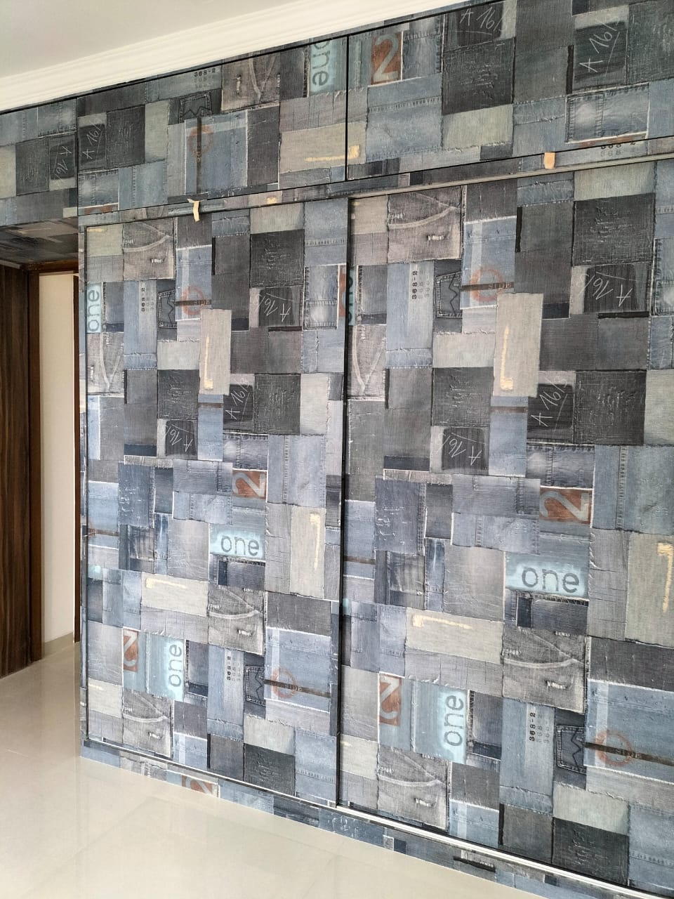 Blue grey patterned laminate wall with matte finish, featuring rectangular patches and numbers, installed in a modern