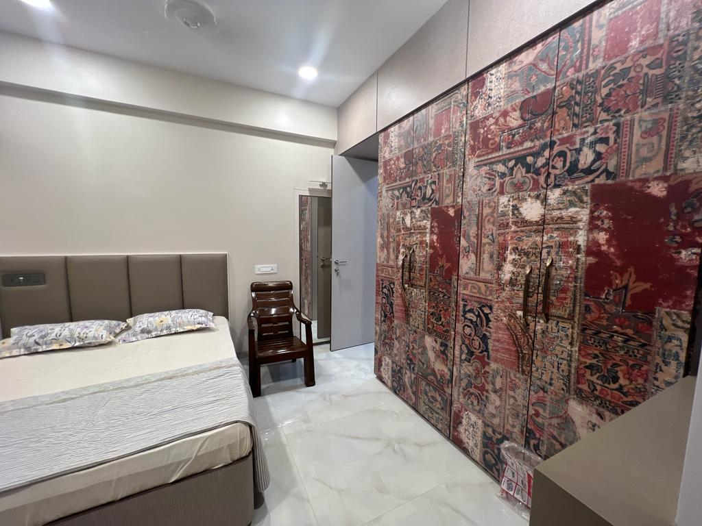 Brown fabric laminate with distressed pattern on bedroom wall, showing textured design and matte finish in interior setting.