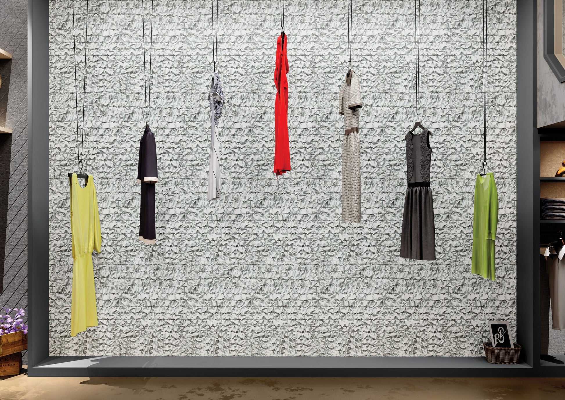 Multi-colored textured laminate wall with crumpled paper pattern and matte finish, displaying hanging clothes in a boutique