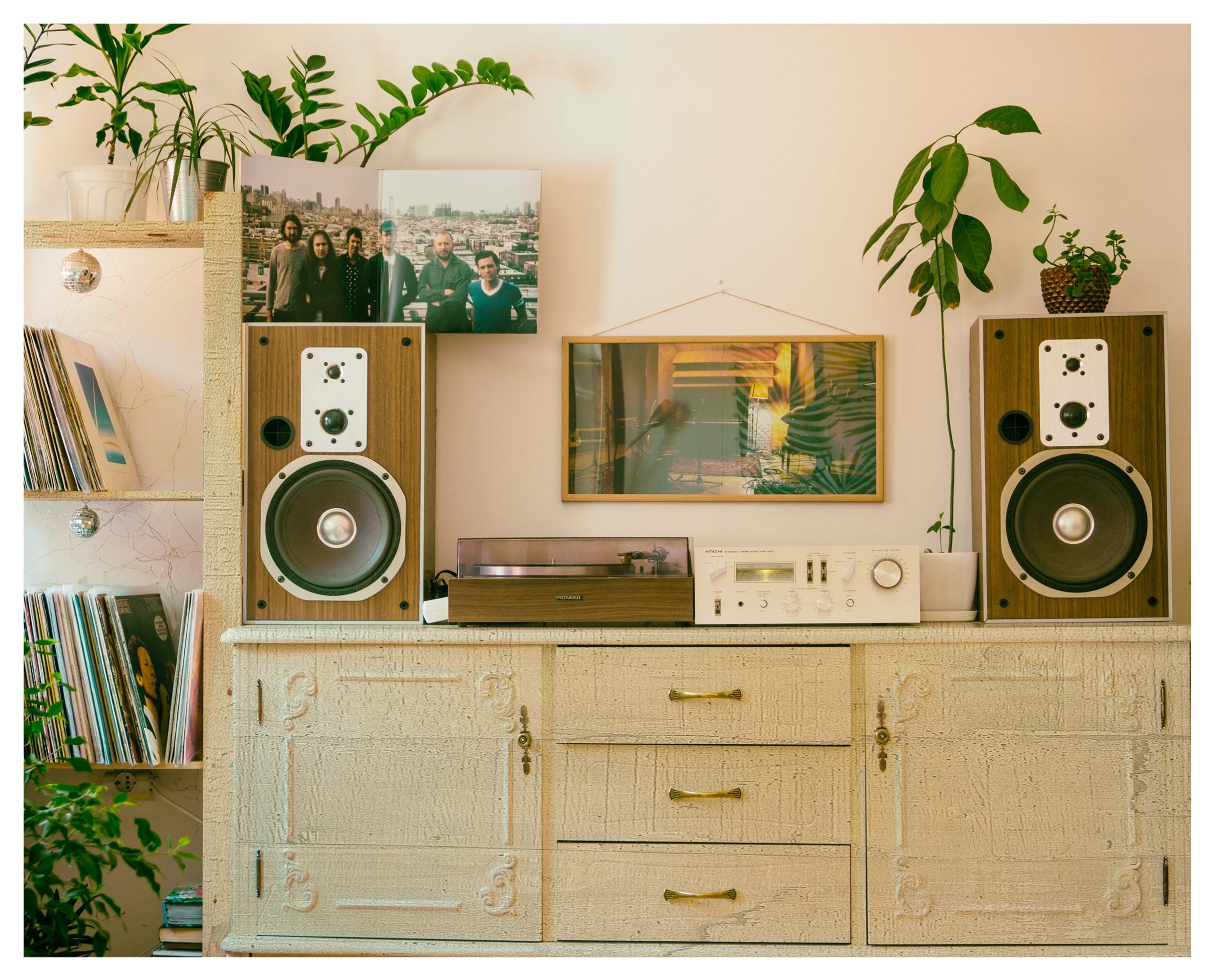 Wood laminate speakers on a cabinet with a wood grain texture and matte finish in a room setting
