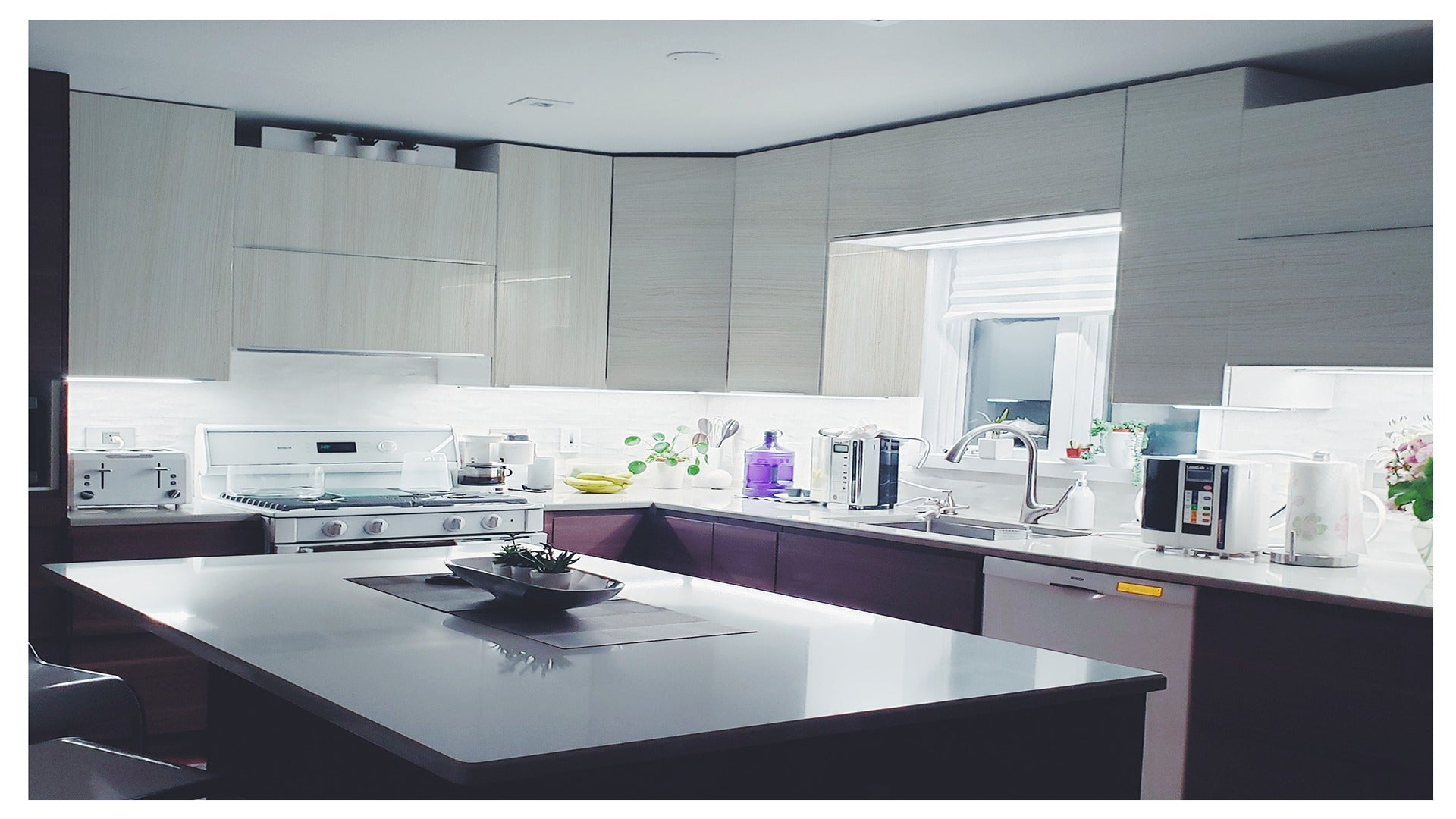 Wood laminate kitchen cabinets with matte finish and wood grain texture in a modern kitchen setting with white countertops