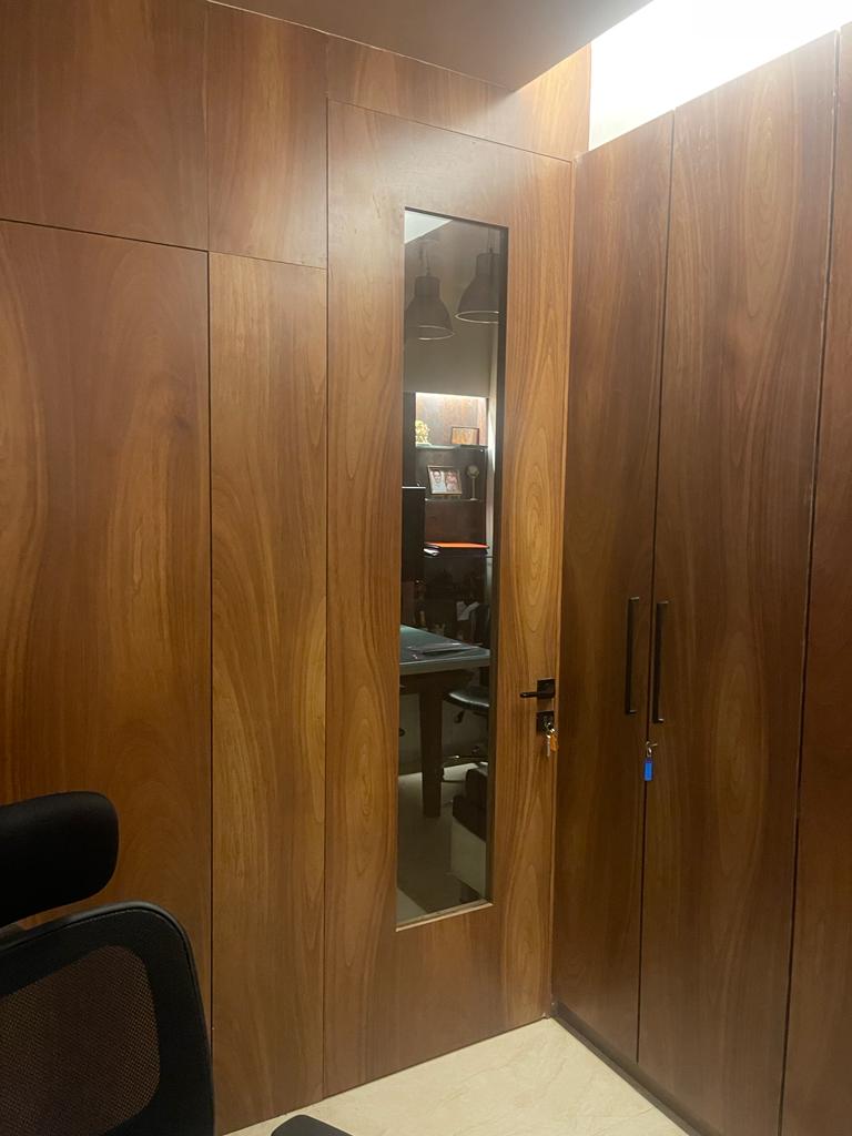 Brown wood grain laminate wall with matte finish and visible wood texture used for cabinet and door in modern interior space