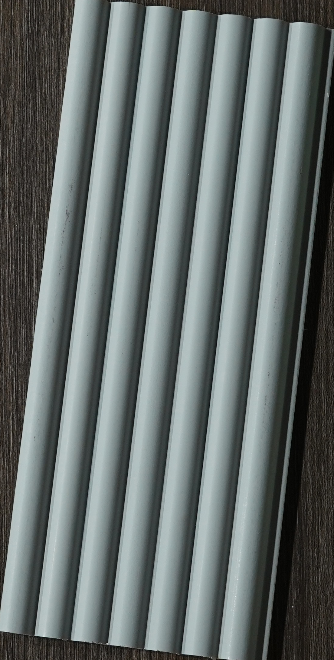 Light blue-grey matte rounded-flute louver sample, MN-8576