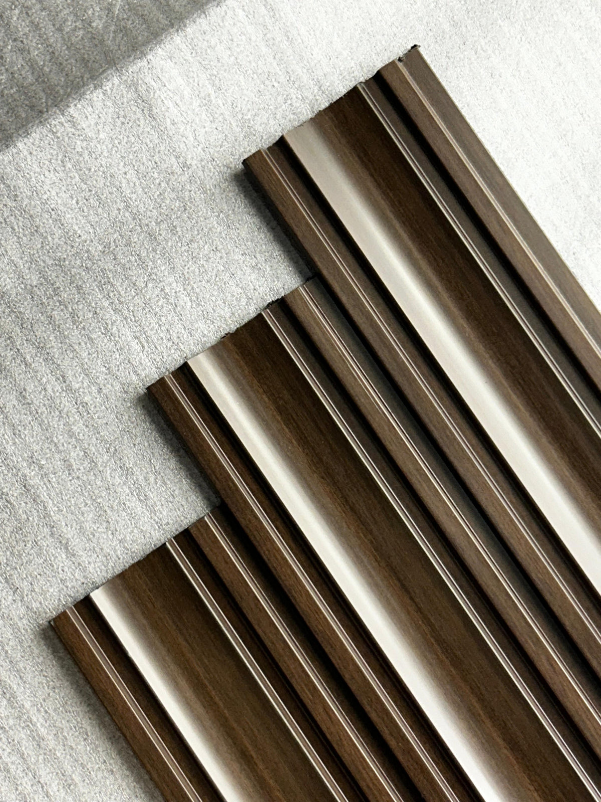 Angled view of dark brown wood-grain fluted louvers, MN 9582