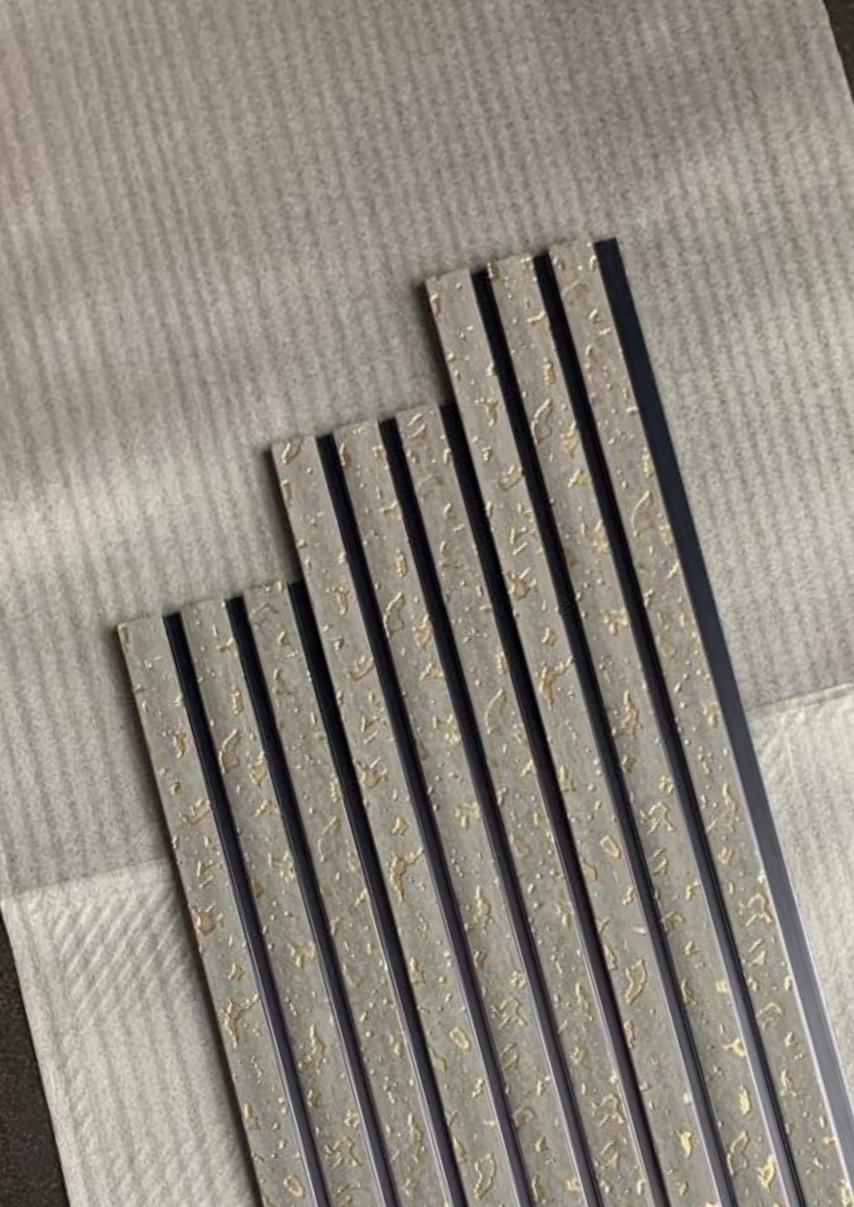 Angled view of grey cork-texture louvers with gold flecks, MN 9586