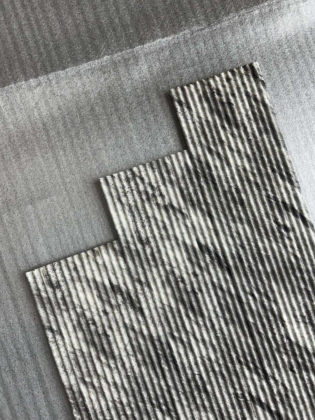 Angled view of fluted louvers in grey and white stone print, code 9594