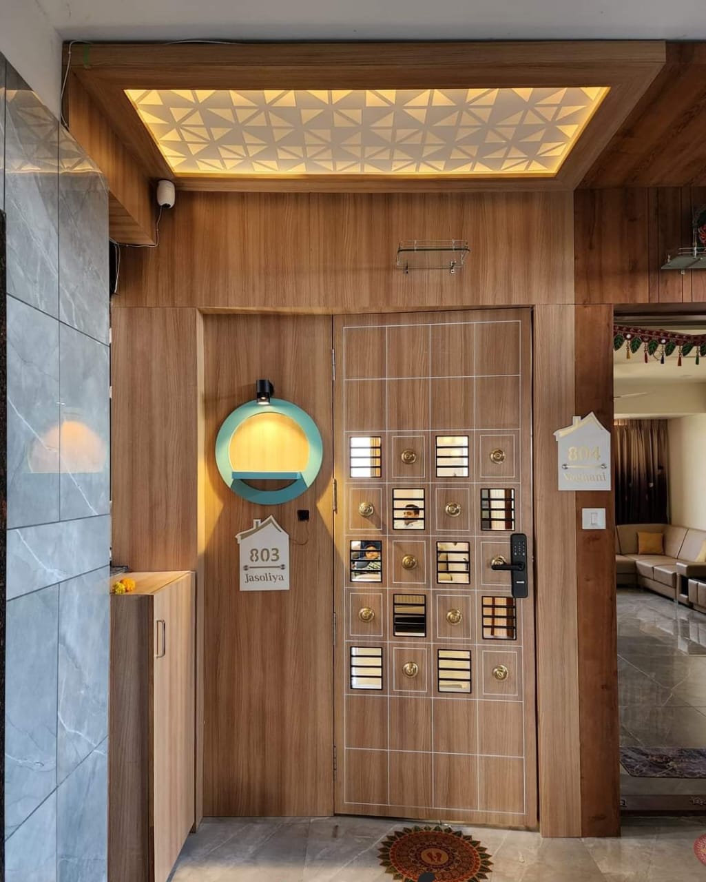Beige wood grain laminate on entrance wall and door with matte finish and visible wood texture in modern interior setting
