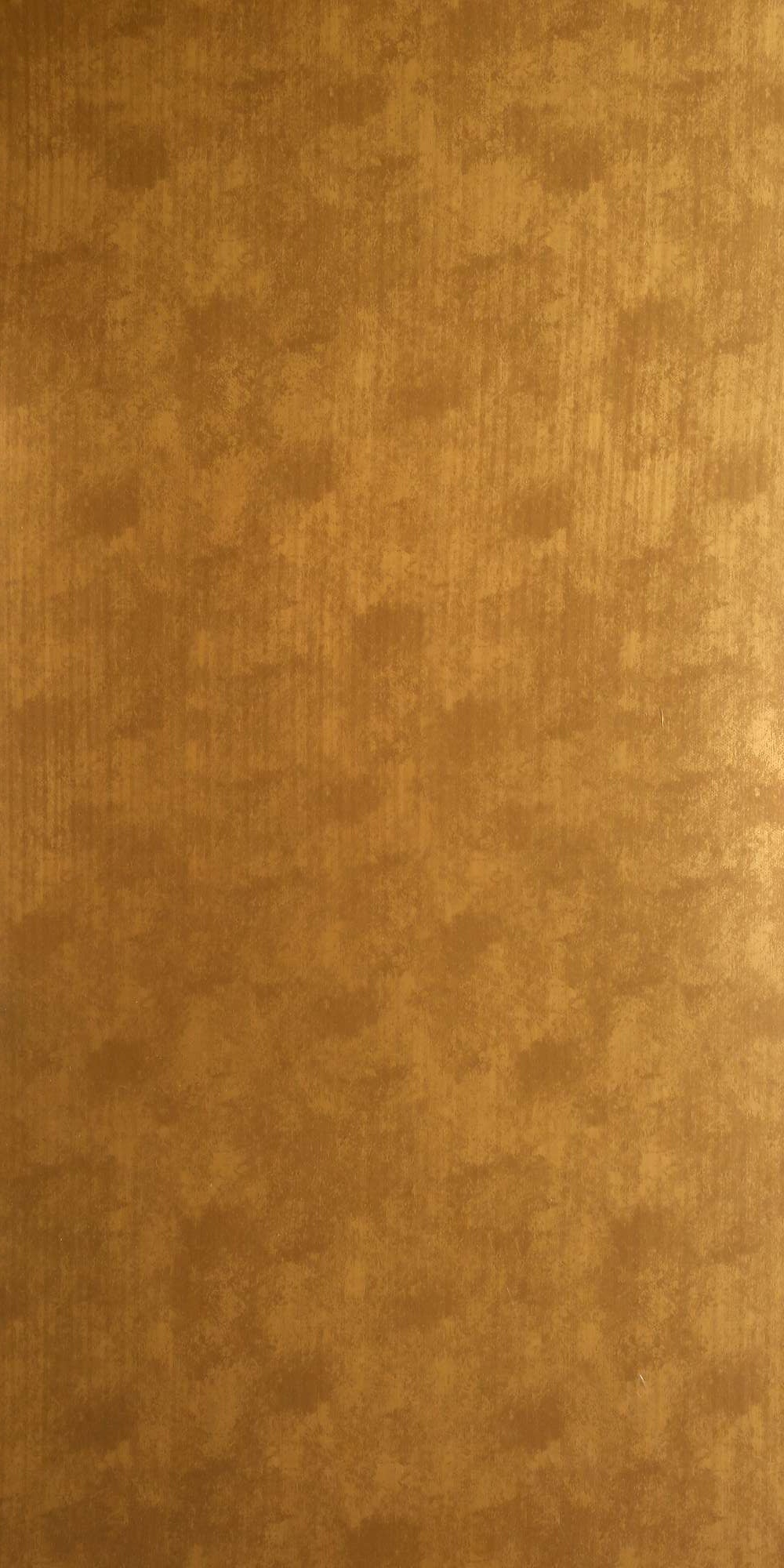 Gold wood veneer laminate with textured finish and wood grain pattern, showing natural texture and subtle variations in tone.