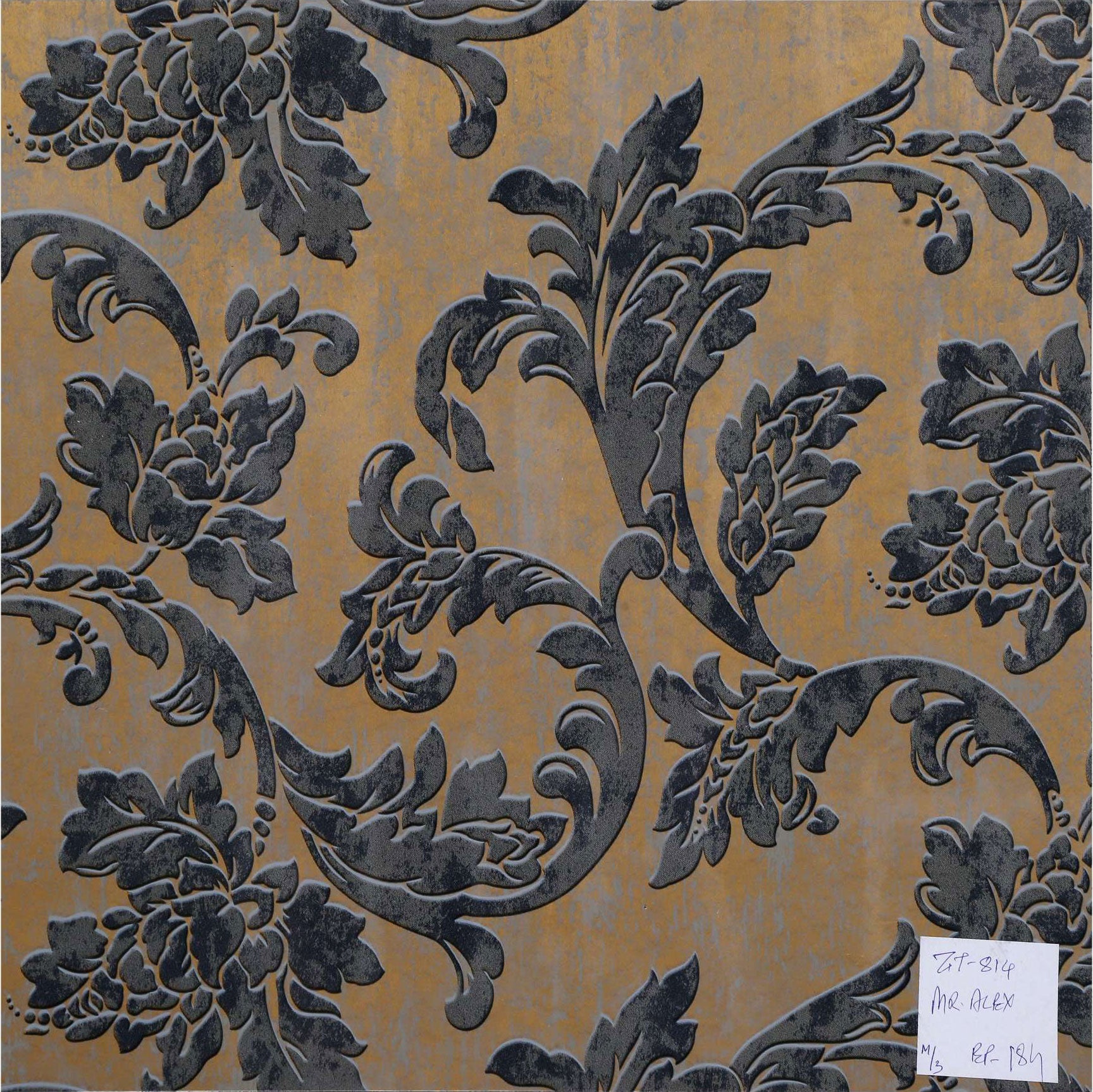 Gold laminate wall panel with embossed black floral pattern and textured finish.