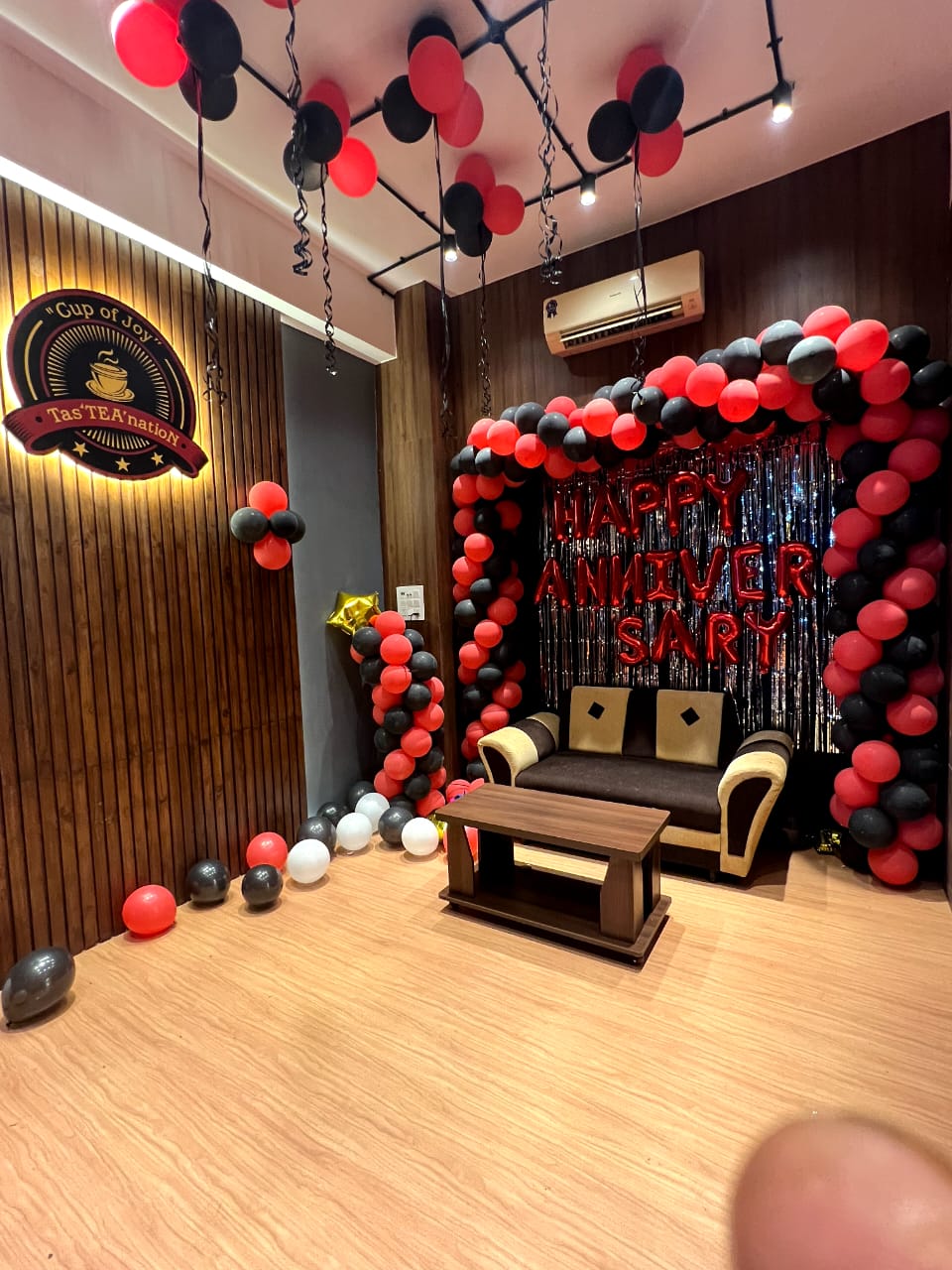 Beige wood grain decorative laminate with matte finish on wall and floor in a decorated room with balloons