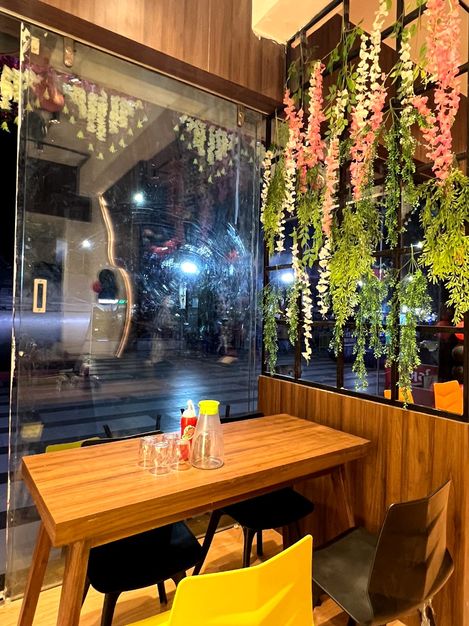 Beige wood grain laminate with matte finish on restaurant table and wall panel, showing wood texture and grain pattern.