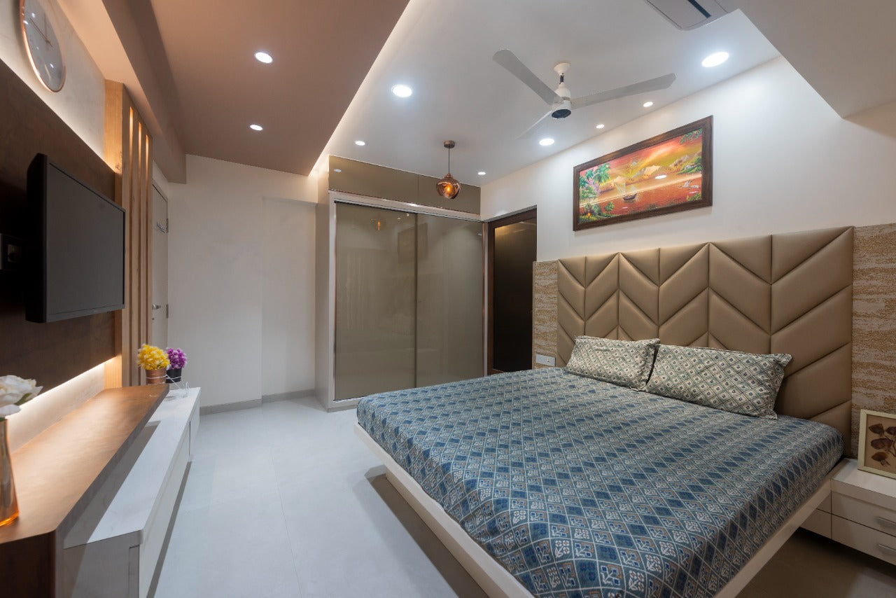 Brown matte laminate used on wardrobe doors in modern bedroom with blue bed and patterned headboard and side table