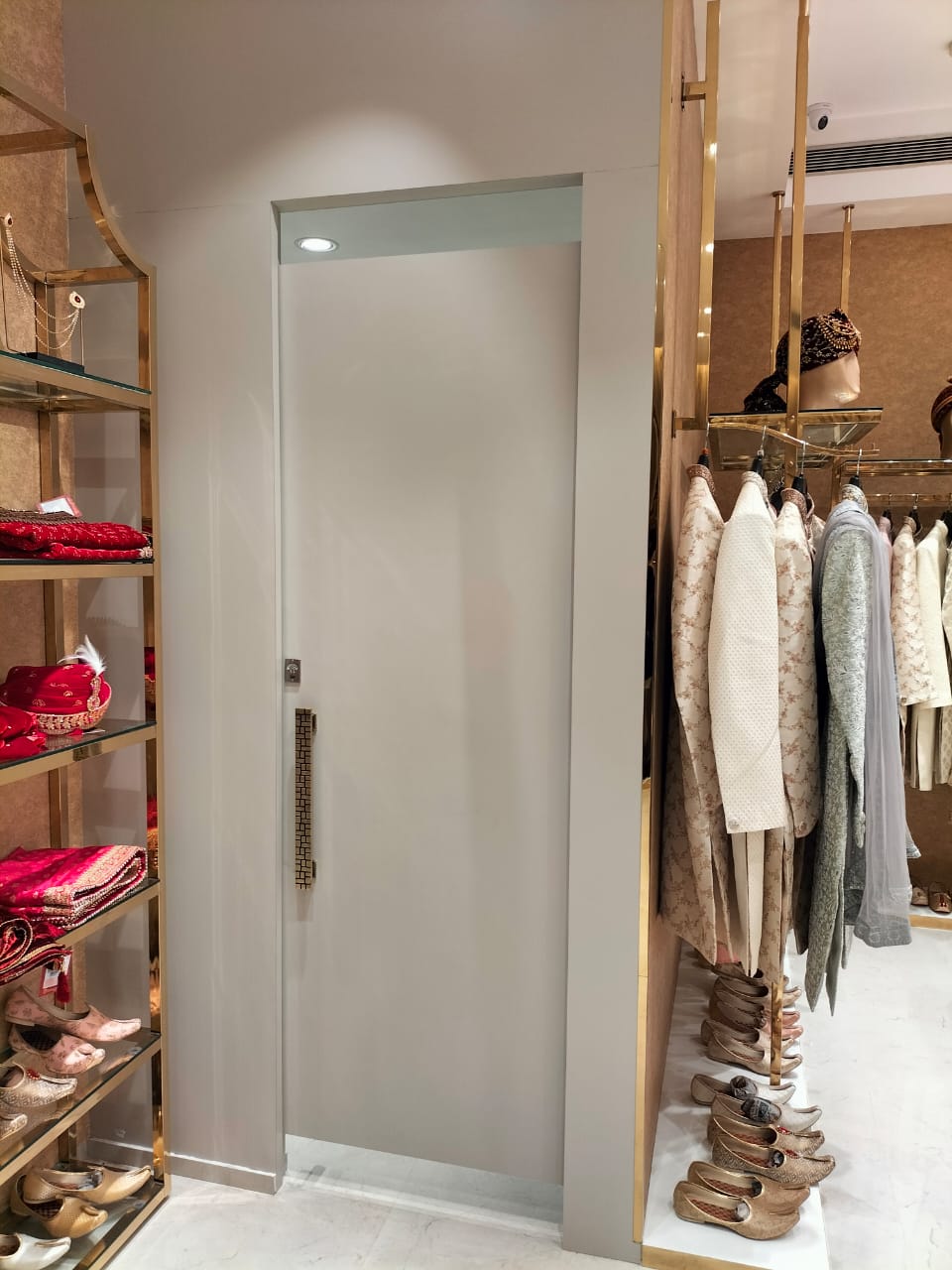 Matte brown solid colour laminate on a door in a clothing store with beige and white decor and accessories.