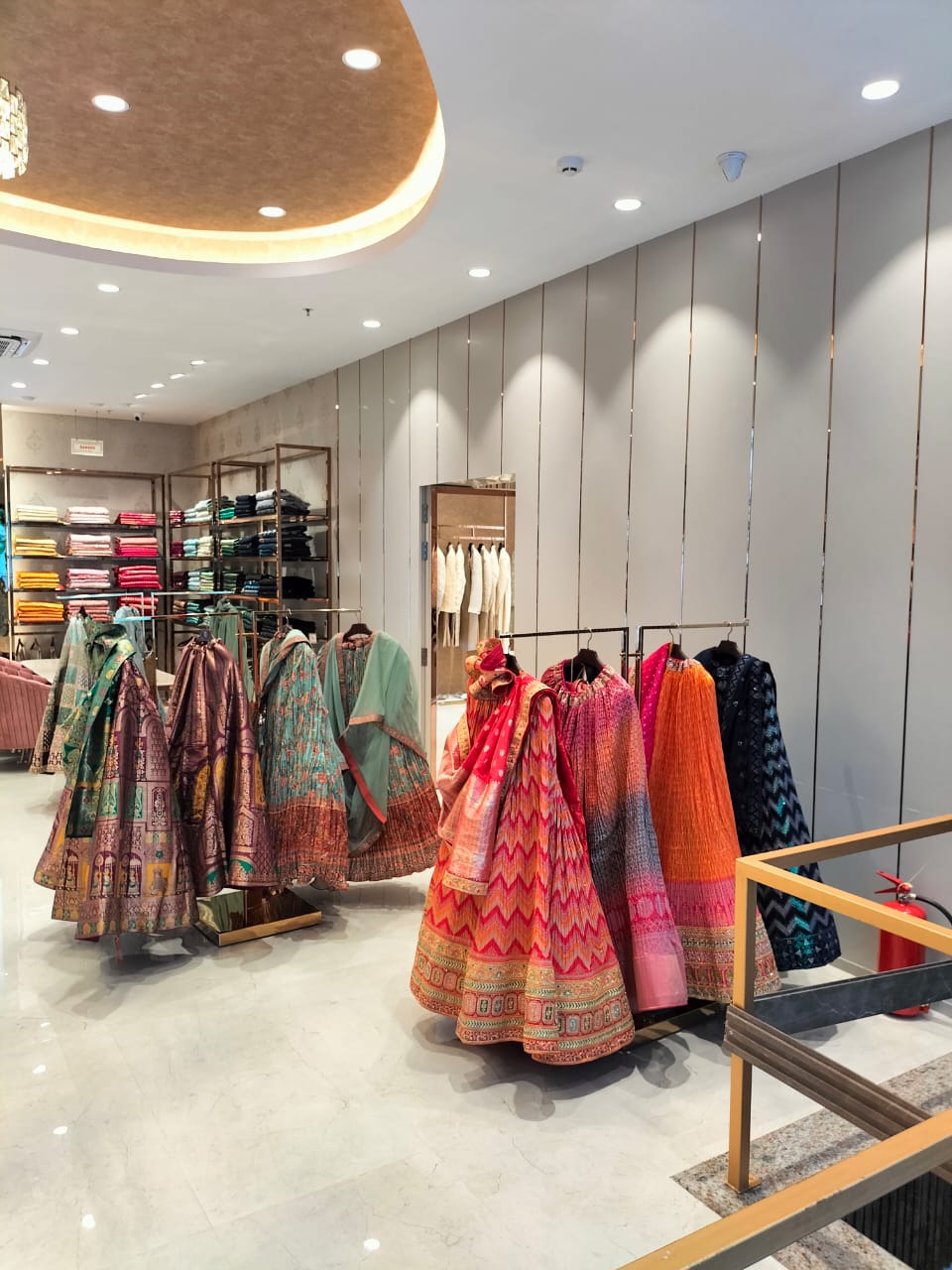 Light grey decorative laminate wall panels in a clothing store with vertical lines and matte finish.
