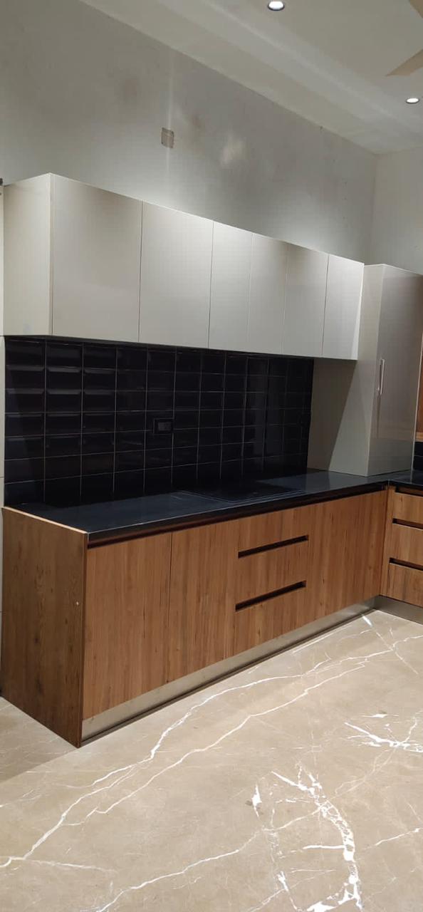 Brown wood laminate kitchen cabinets with matte finish and visible wood grain in a modern interior setting
