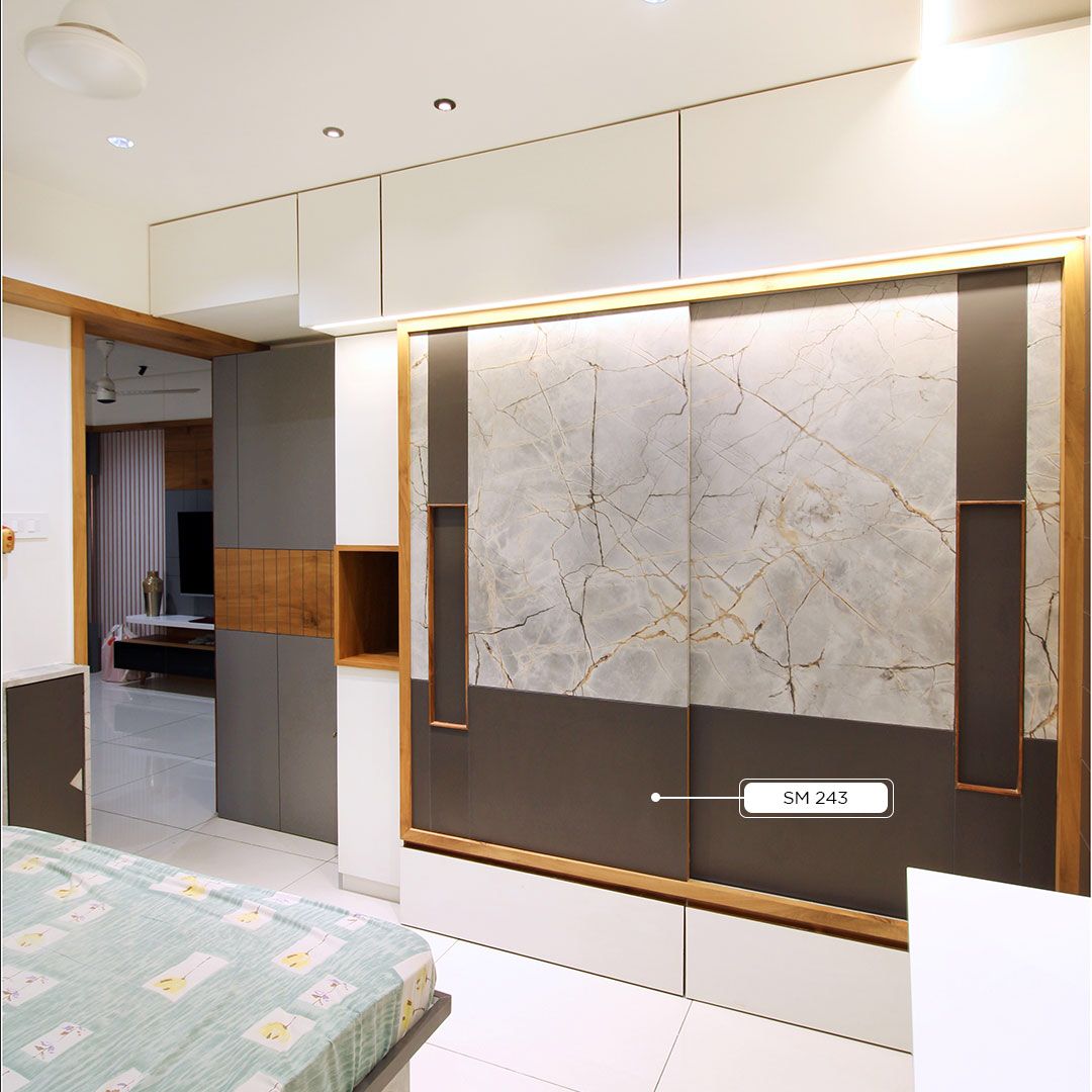 Multi-coloured marble patterned laminate with gold veining and matte finish on wardrobe doors in modern bedroom interior