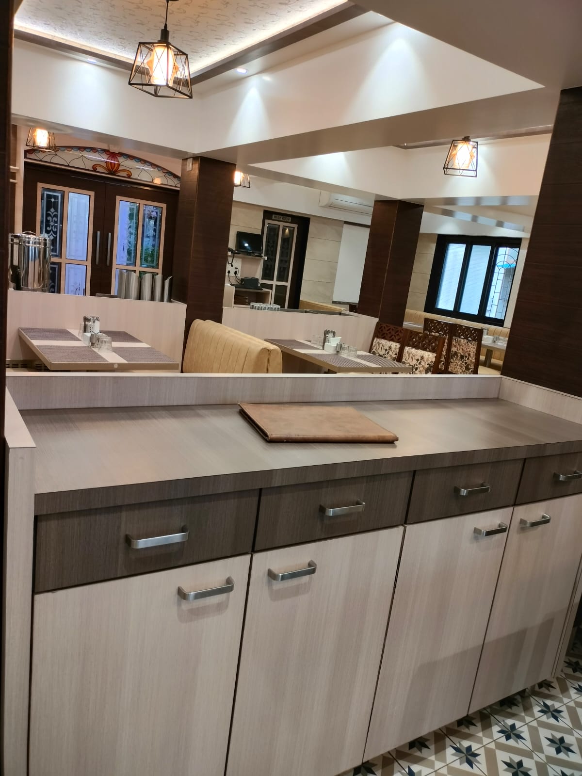 Brown wood laminate cabinet with matte finish in a restaurant setting showing wood grain texture and modern design