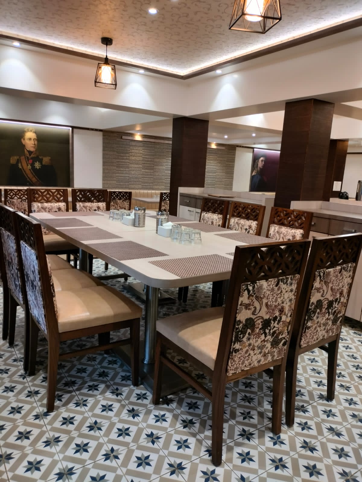 Brown wood laminate used on pillars in a dining room with patterned floor tiles and decorative chairs