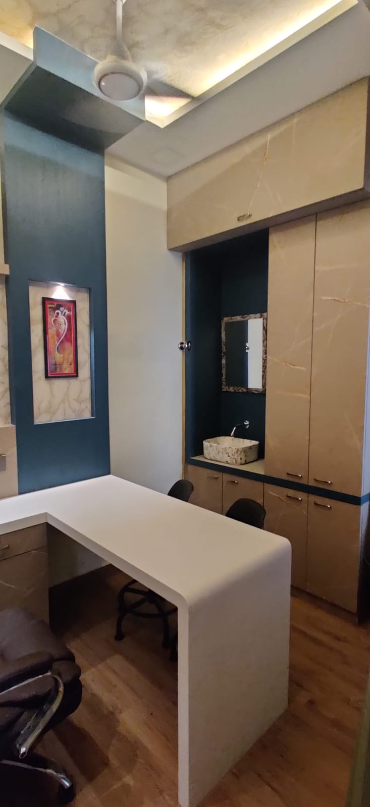 Wood laminate wall and floor installation in a modern room with cabinets and a sink area.