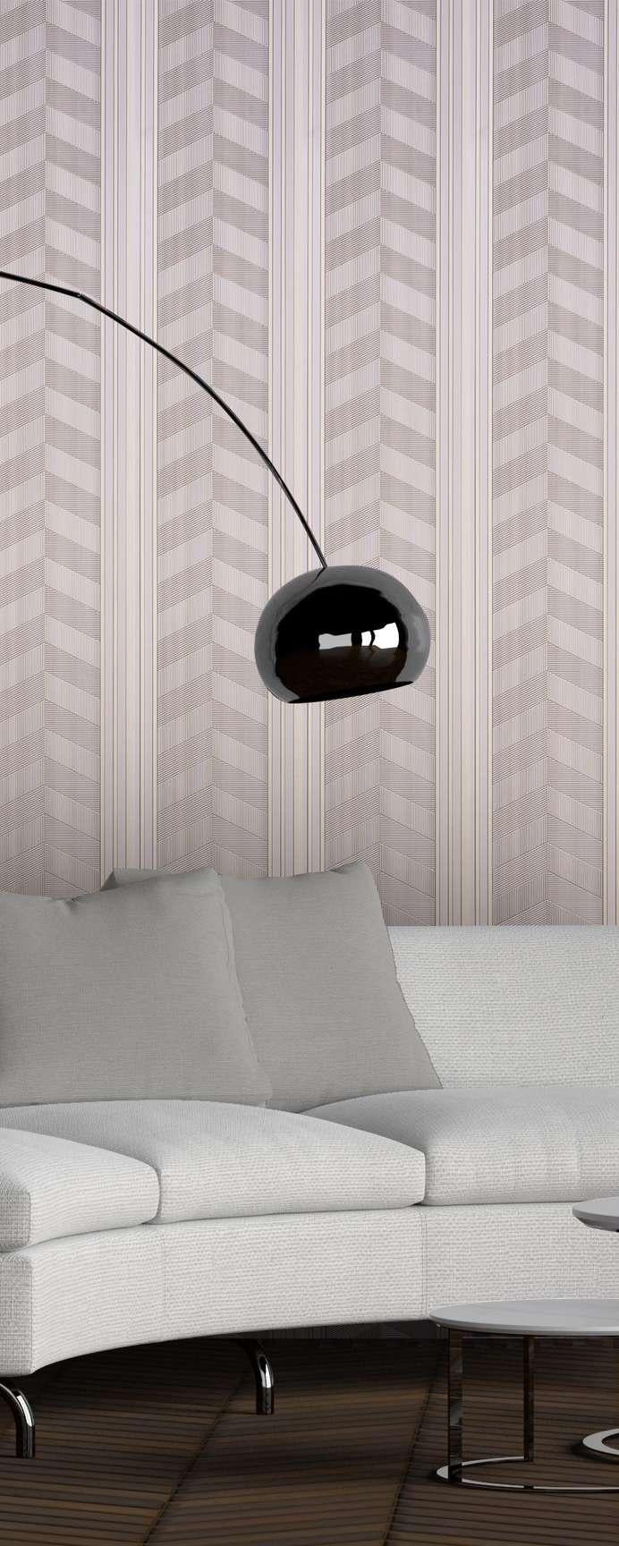 Beige patterned louvers with chevron design on wall behind modern sofa and sleek black lamp in a minimalist setting