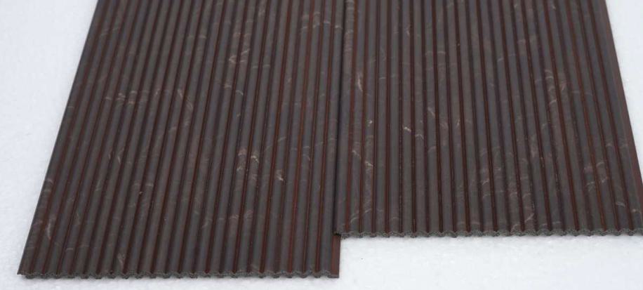 Brown marble louvers with glossy finish and white veining, arranged in parallel slats with visible texture and subtle sheen.
