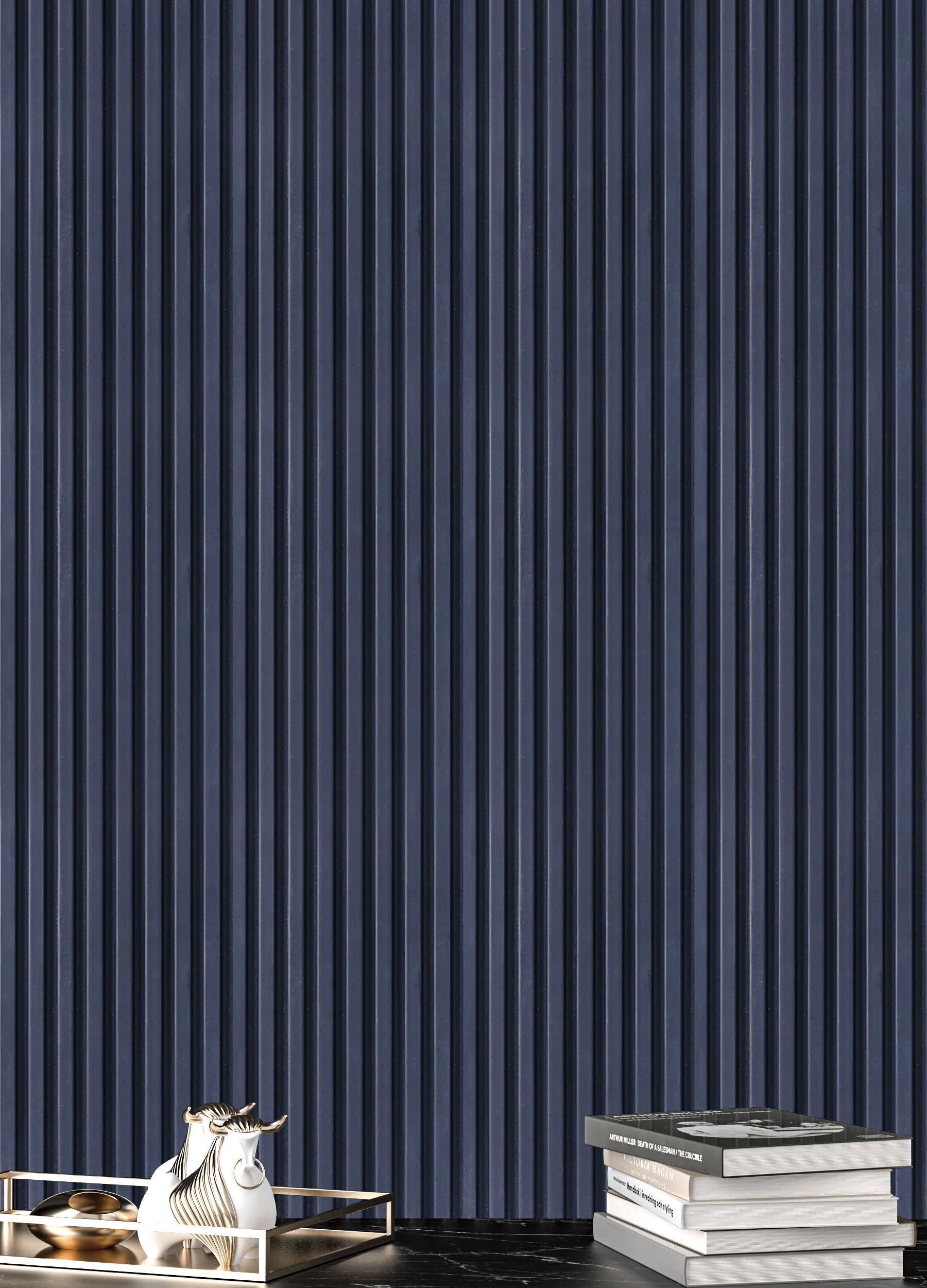Grey charcoal louver with vertical slats and smooth finish, displayed with decorative items and books on a dark surface.
