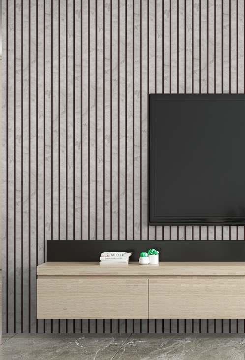 Grey marble louver with vertical slats and subtle veining, used as wall cladding behind a TV and wooden cabinet.