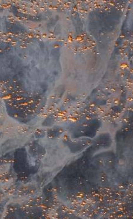 Grey marble louver with gold flecks and swirling pattern, showing natural stone texture and veining details.