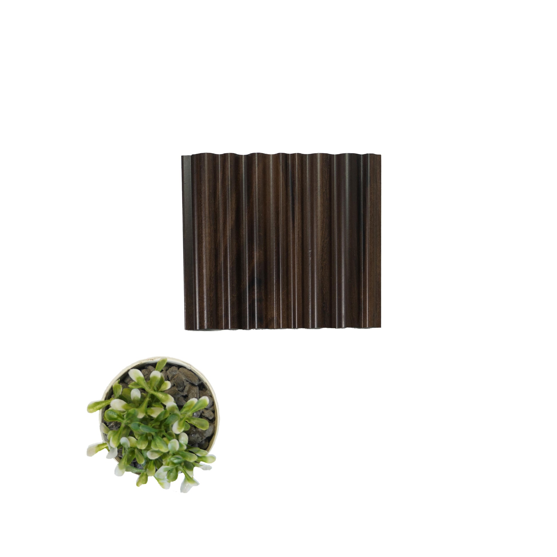 Dark brown wood louver with visible wood grain texture and glossy finish, alongside a small potted plant for scale comparison