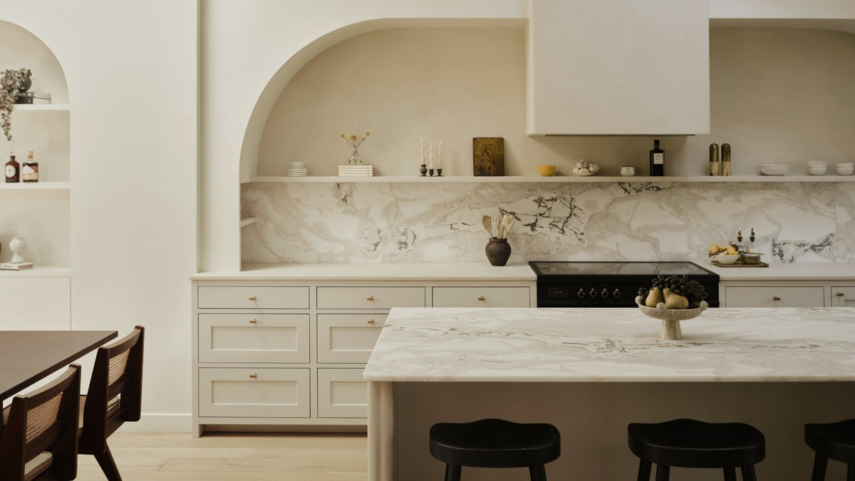 White laminate kitchen with marble laminate counter and marble wall panel backsplash.